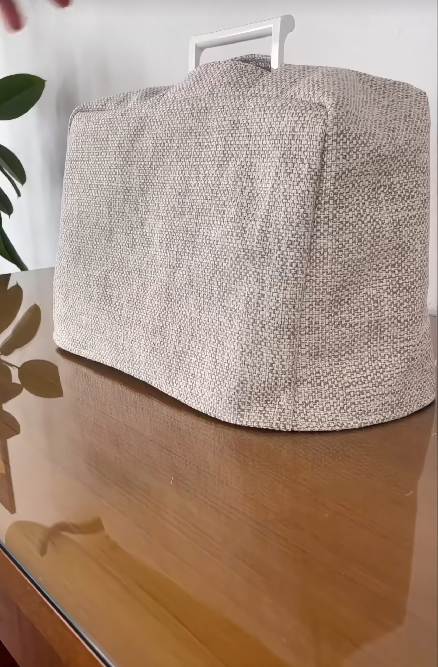 Side-by-side comparison: breathable cotton dust cover on the left allowing airflow; plastic bag cover on the right trapping humidity against the machine
