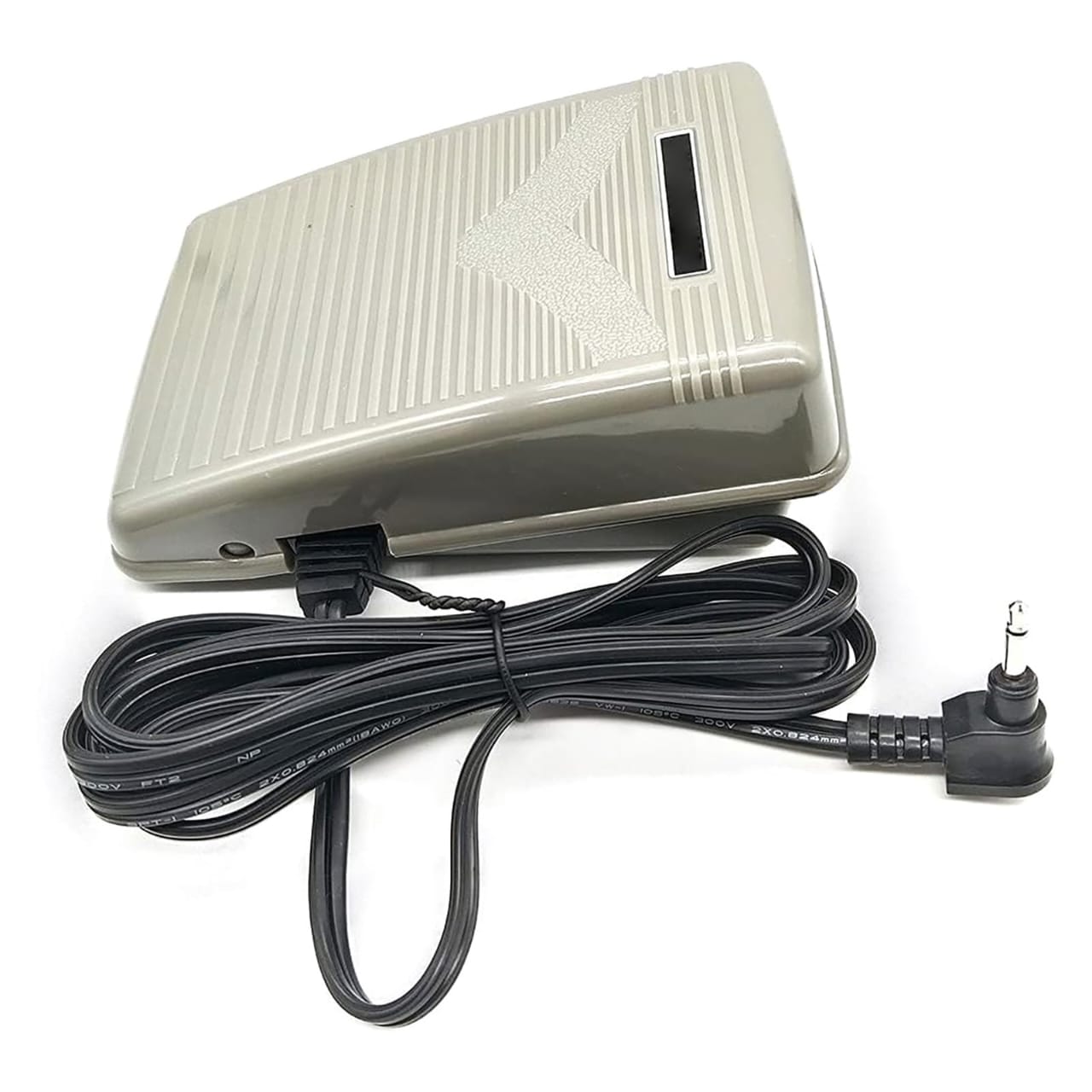 Photograph of a sewing machine foot pedal on the floor with cable connected to the machine
