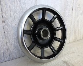 Photograph of a sewing machine handwheel on the right side of the machine