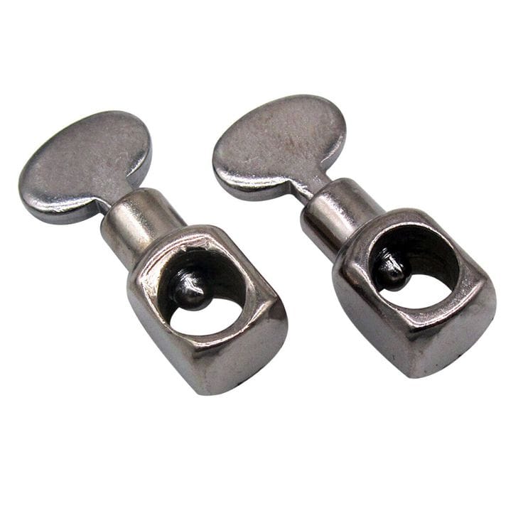 Close-up photograph of a sewing machine needle clamp and screw securing the needle in position
